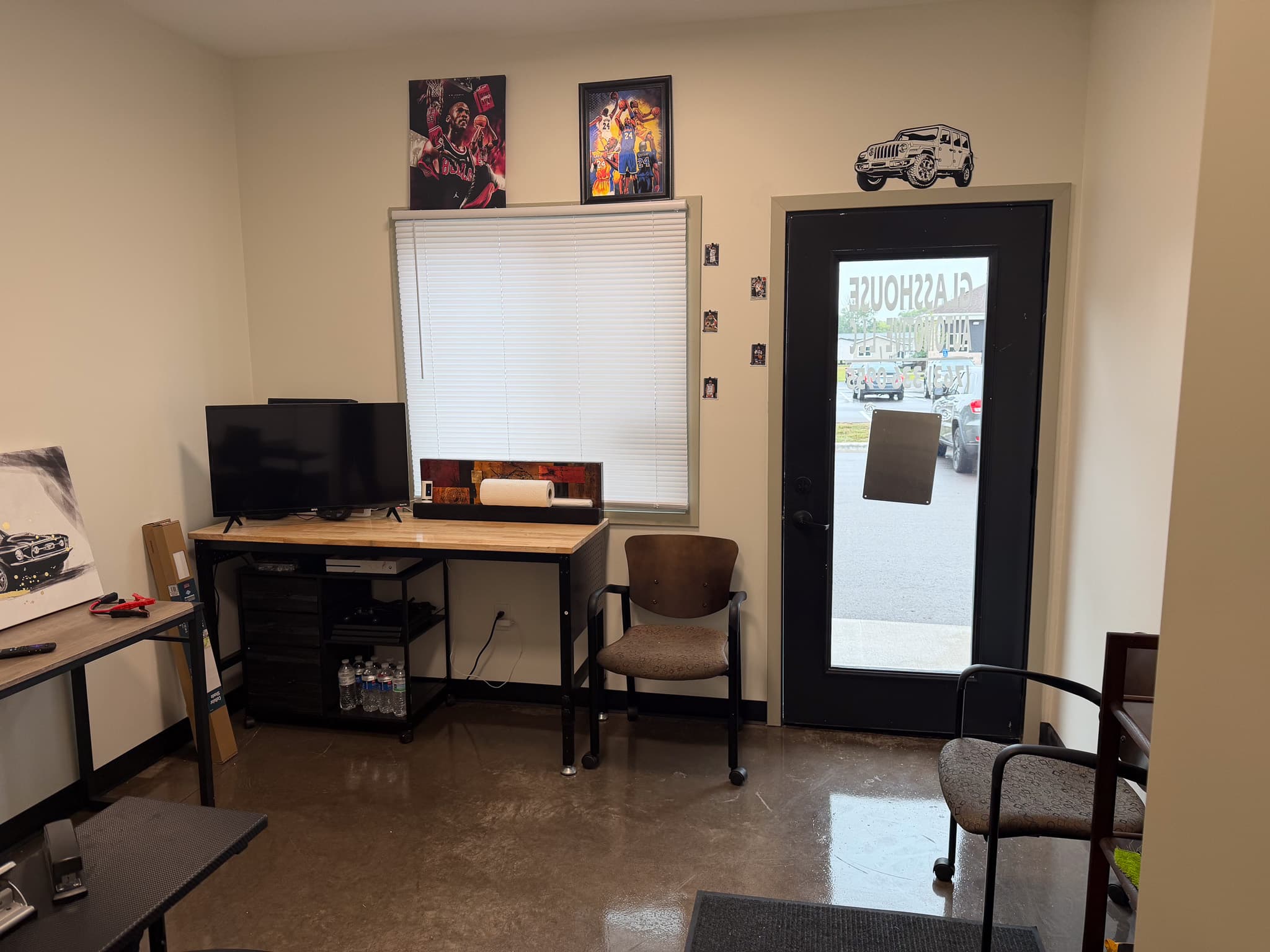Waiting area inside Glasshouse Automotive, looking toward the entrance and television
